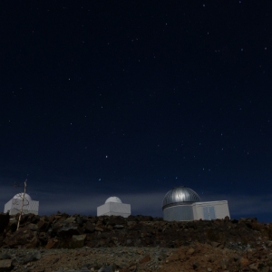 Starry and moonlit night over telescopes in ESO La Silla Observatory, Chile