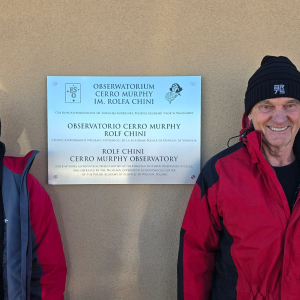 Miguel Murphy and Rolf Chini next to the memorial plaque of their observatory